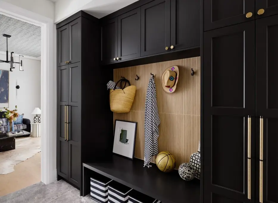 Mudroom with black lockers, an oak slat wall and hooks