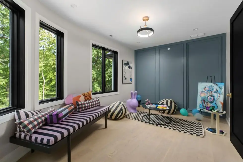 Bright playroom with a striped daybed and a slate-blue panelled wall